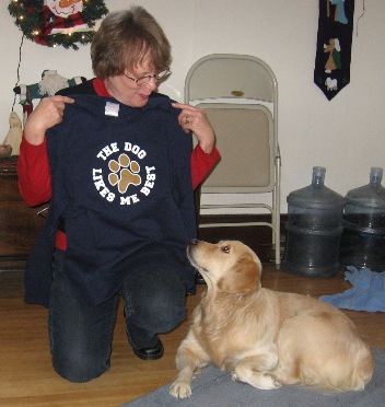 mollie woman holding t shirt that says the dog likes me best